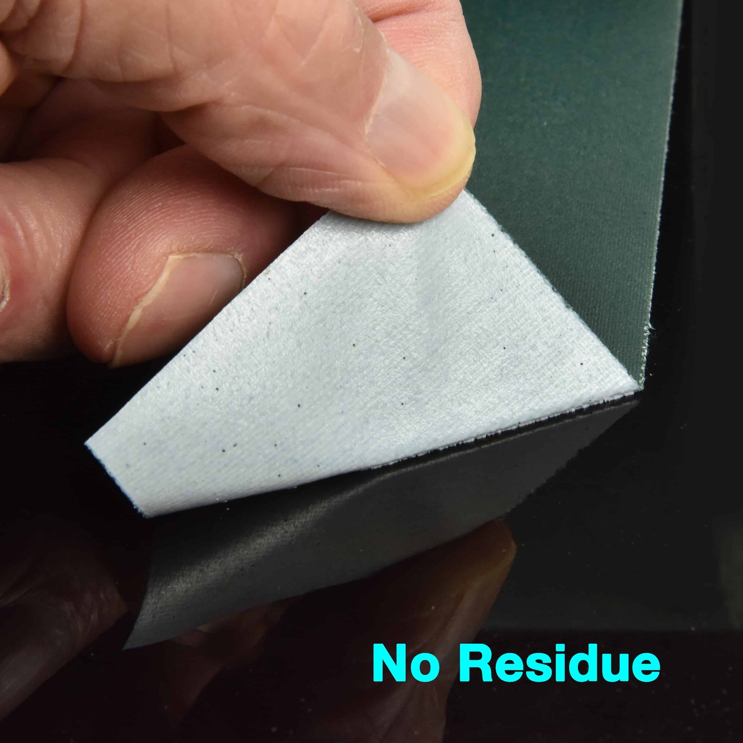 Close up of forest green gaffer tape peeling off surface without leaving sticky residue