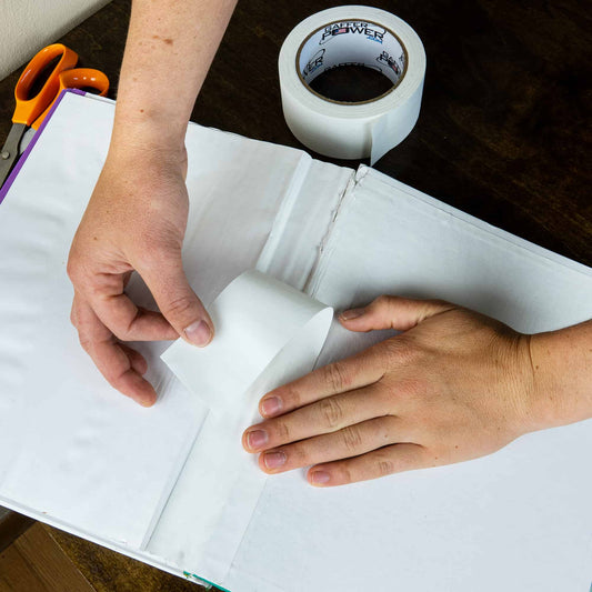 man restoring his book with American made bookbinding cloth tape