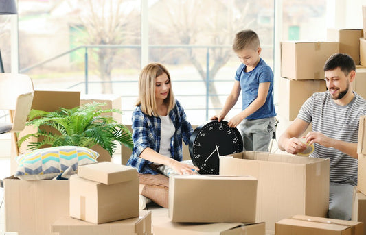 family using clear packing tape to tape boxes