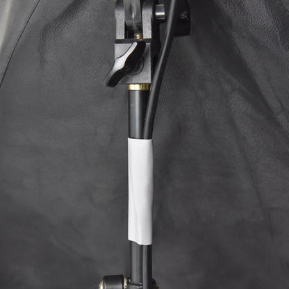 Grey gaffer tape attaching electrical cable to light stand for clean cable routing on film or photography set